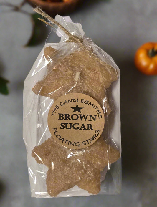 Two small star-shaped brown sugar floating candles packaged in clear plastic with a cardboard label reading 'Brown Sugar'.