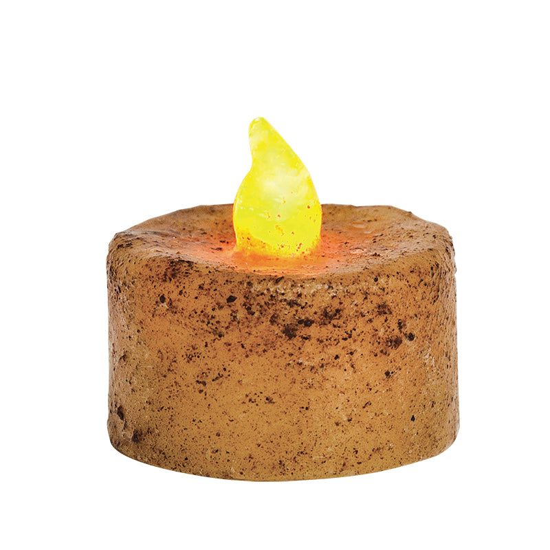 An ivory-colored LED tealight candle with a textured wax coating and an amber-colored flickering light.