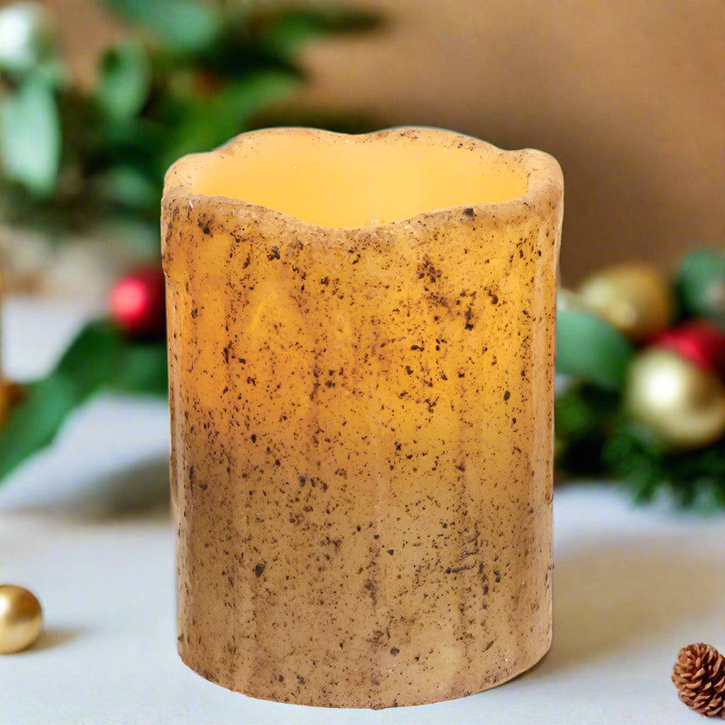 A burnt ivory candle holder in a pillar shape with an on/off and timer mode features.