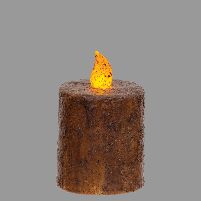 Decorative candle with a flame on a wooden surface