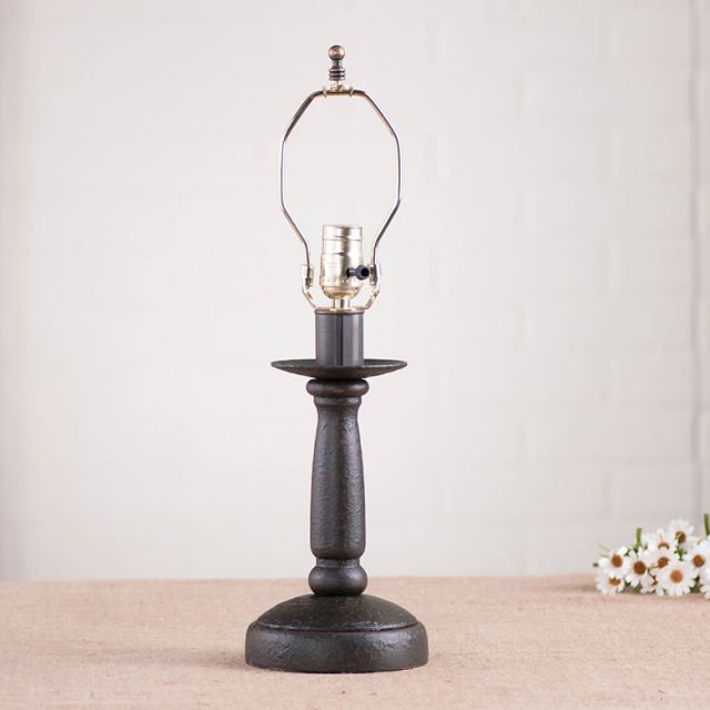 Butcher's Lamp Base in Americana Black on white background with daisies beside it.