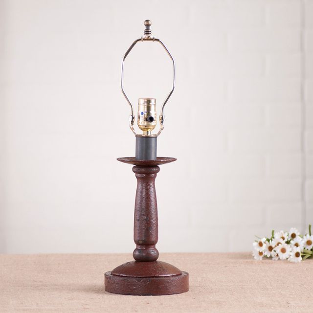 Butcher's Lamp Base in Americana Red on white background with daisies beside it.