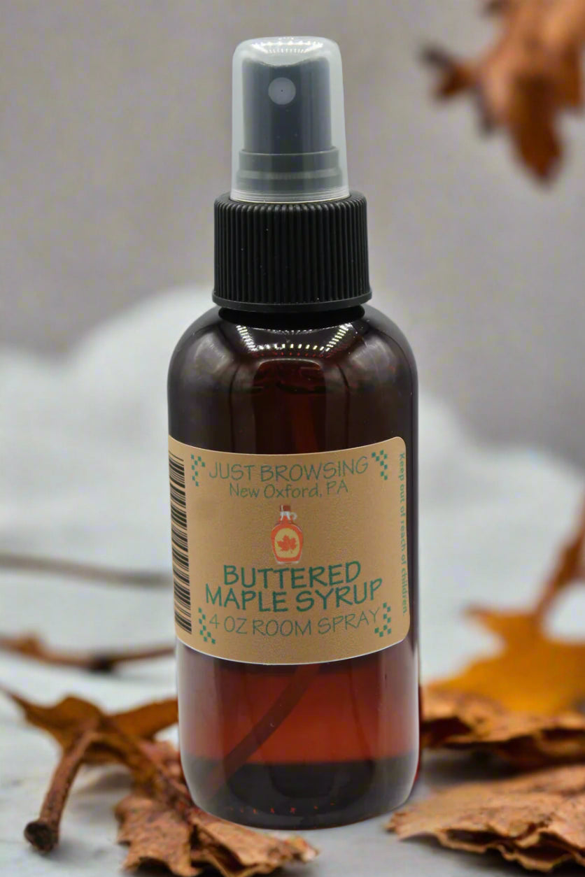 A 4oz bottle of Buttered Maple Syrup Room Spray with a mist spray top. The label features a stack of pancakes with maple syrup and butter.