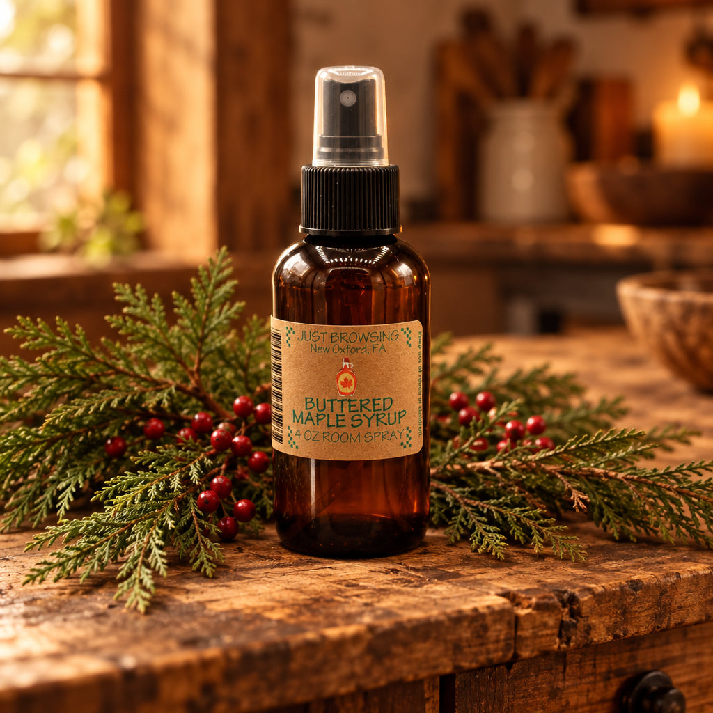 A 4oz bottle of Buttered Maple Syrup Room Spray with a mist spray top. The label features a stack of pancakes with maple syrup and butter.