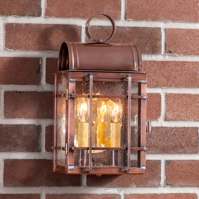 Copper outdoor wall lantern on a brick wall