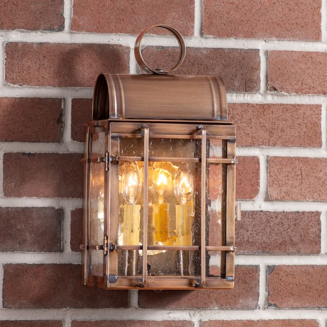 Bronze outdoor lantern on a brick wall