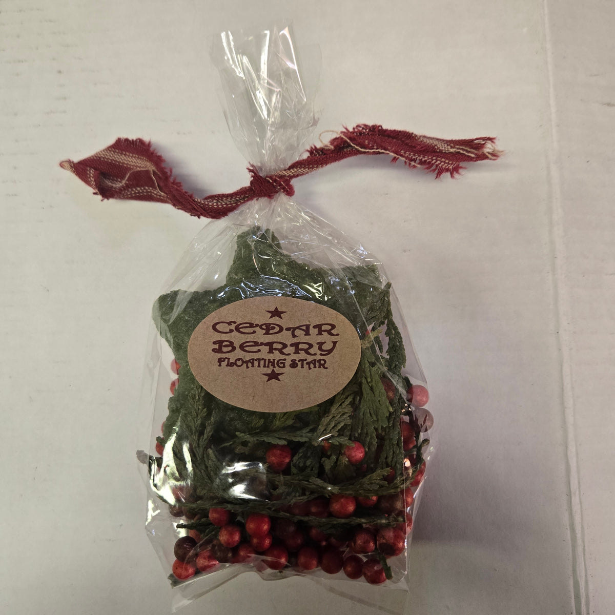 Packaged cedar berry plant with a label on a white background