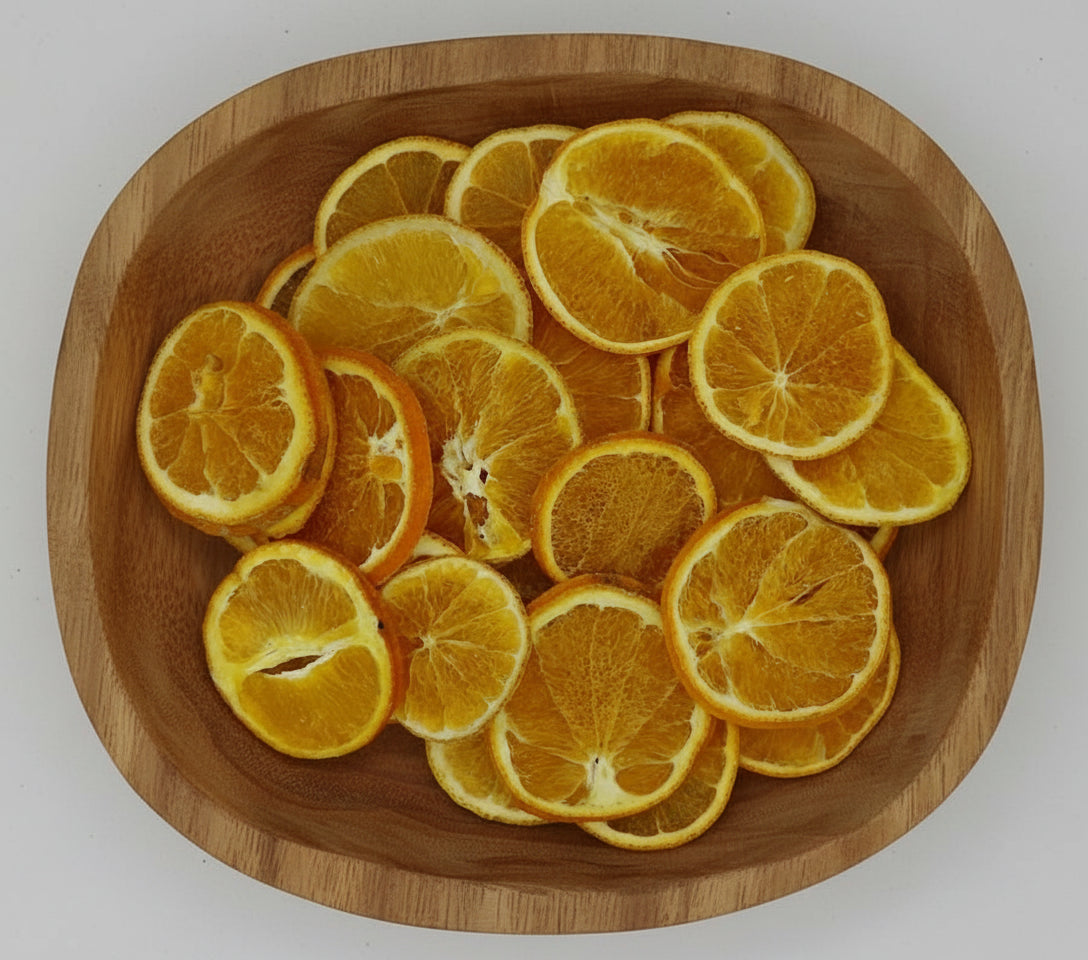 Dried orange slices in a wood bowl.