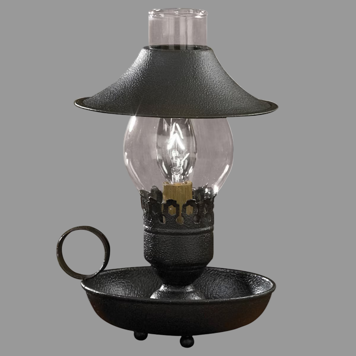 A black chamberstick lamp with an adjustable shade and a metal base, featuring a clear glass chimney and a black-colored lamp base.
