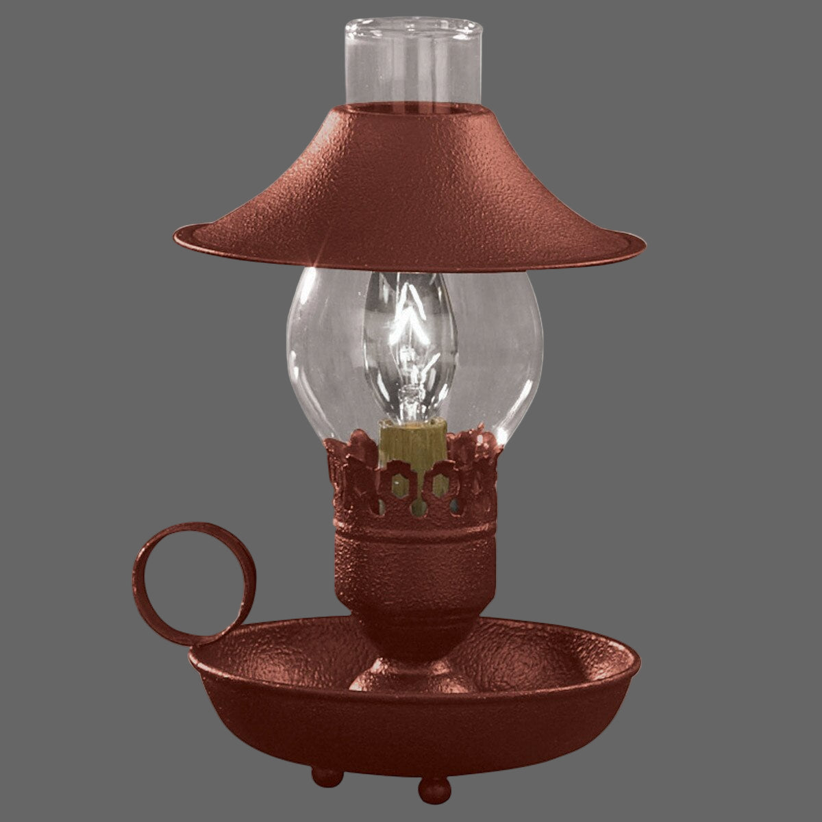 A red chamberstick lamp with an attached shade, featuring a bulb encased in a clear glass globe with a metal base and a brown matte finish.