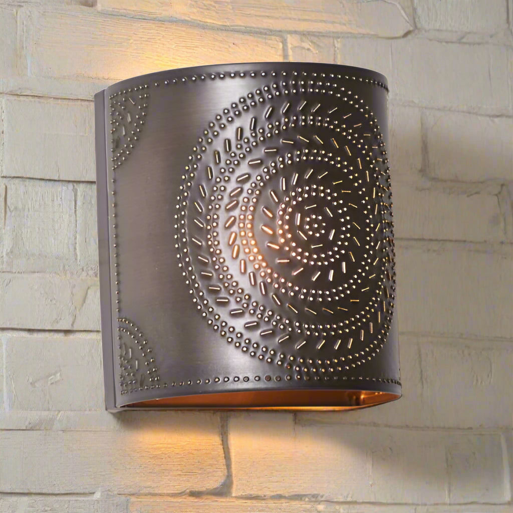 Decorative wall sconce with intricate metalwork on a white background