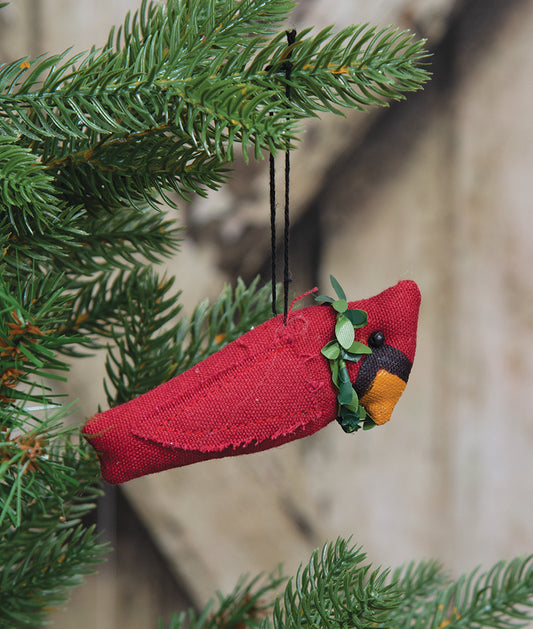 Christmas cardinal ornament hanging on Christmas tree