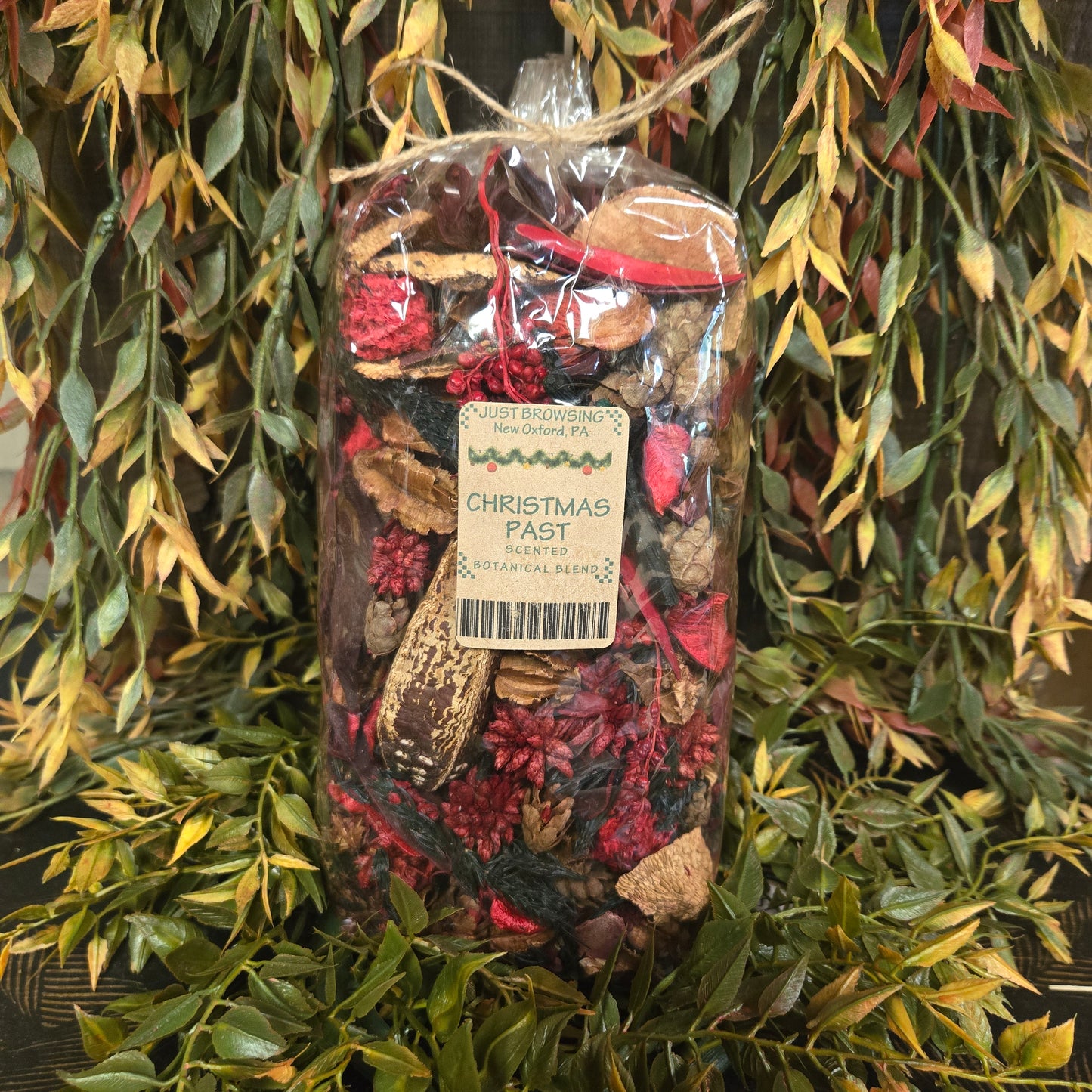 Bag of Christmas pastries with a label on a green leafy background