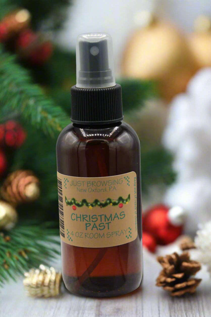 Brown spray bottle with a label on a gray background with christmas decor