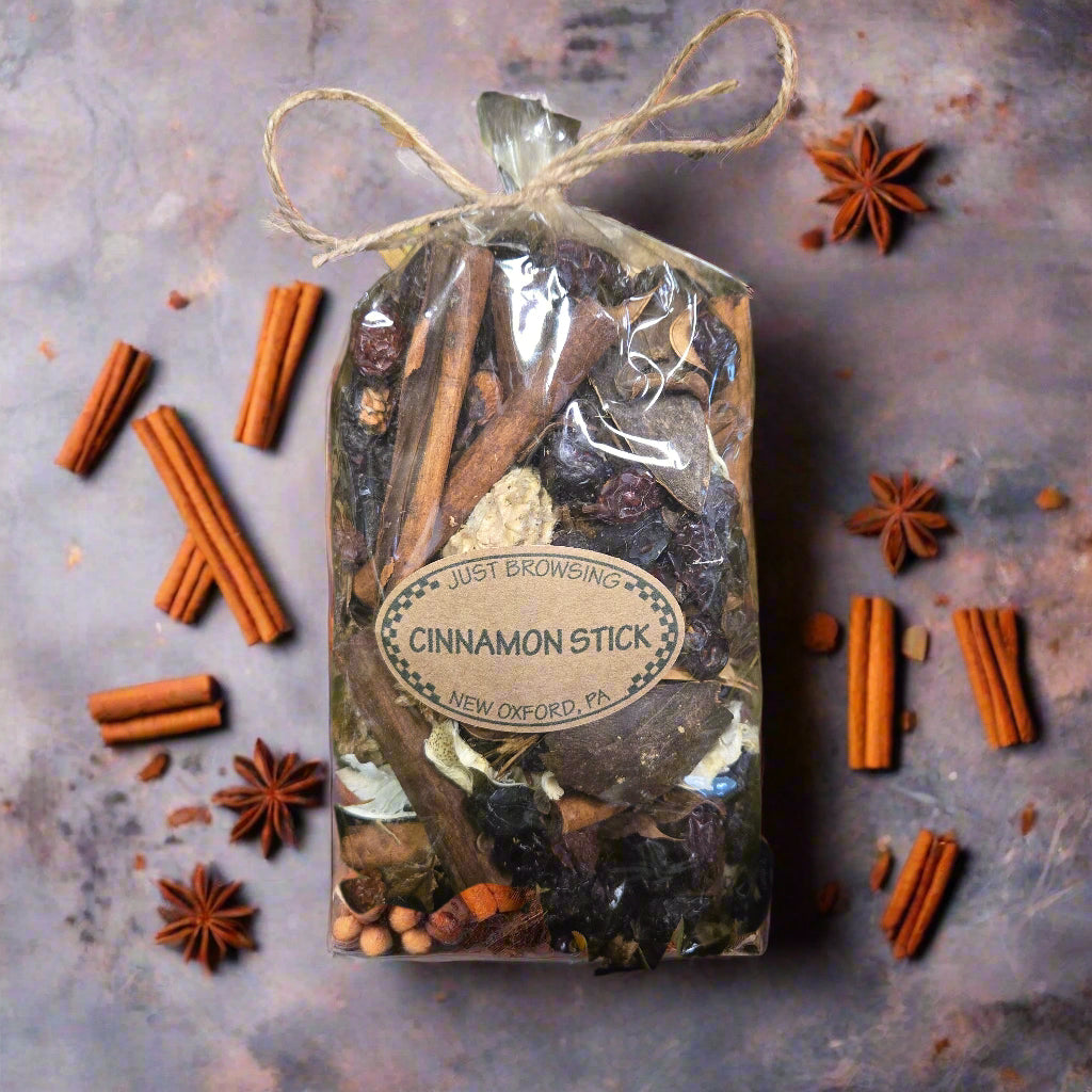 Cinnamon stick package with a label on a bed of green leaves