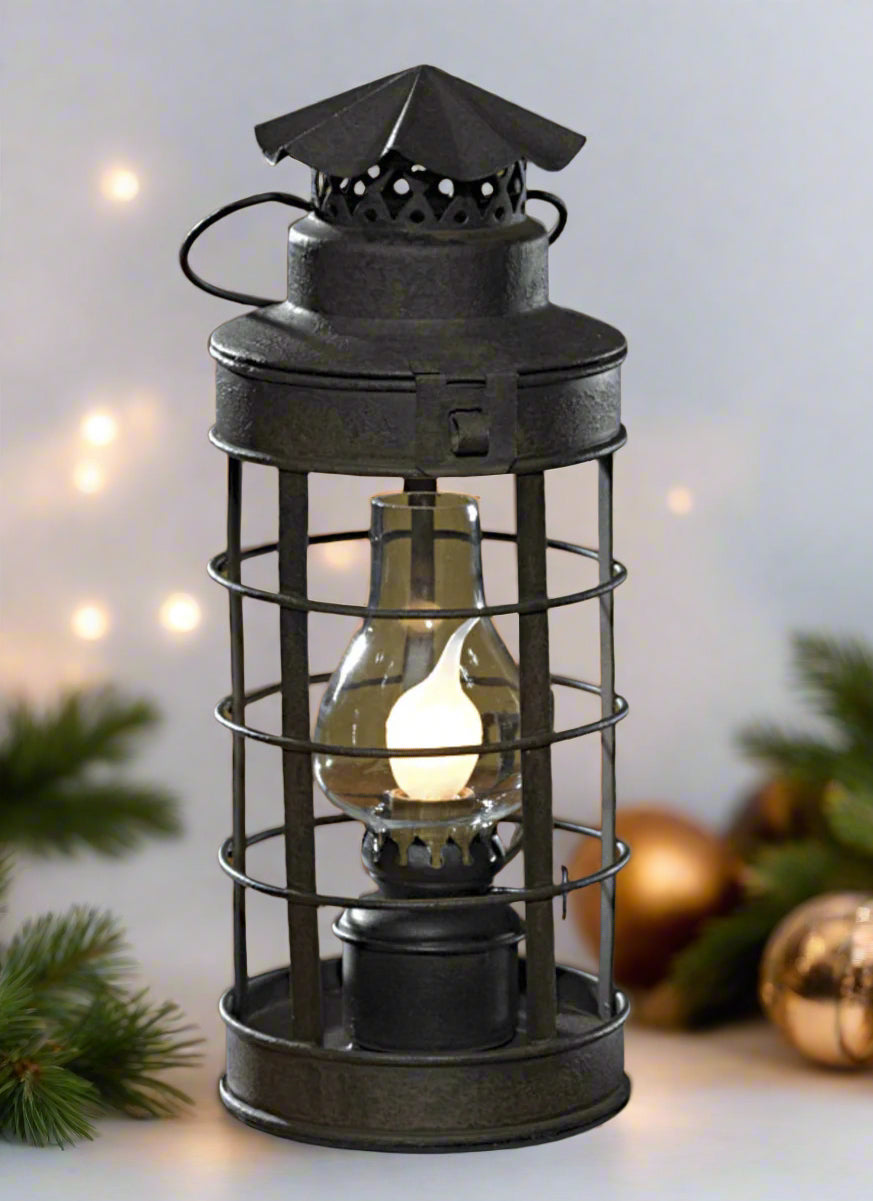 Black accent light with globe displayed with Christmas decorations