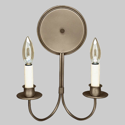 Bronze wall sconce with two candle-style light fixtures on a gray background