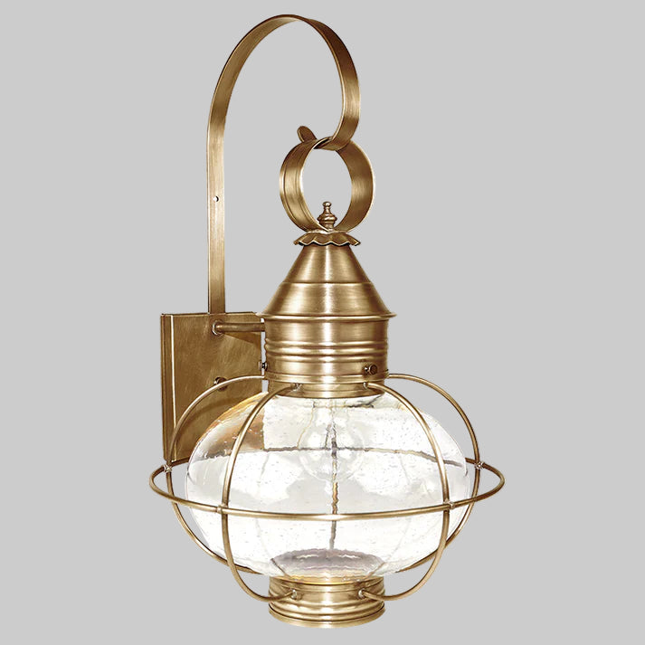 Brass wall-mounted lantern with glass shade on a white background