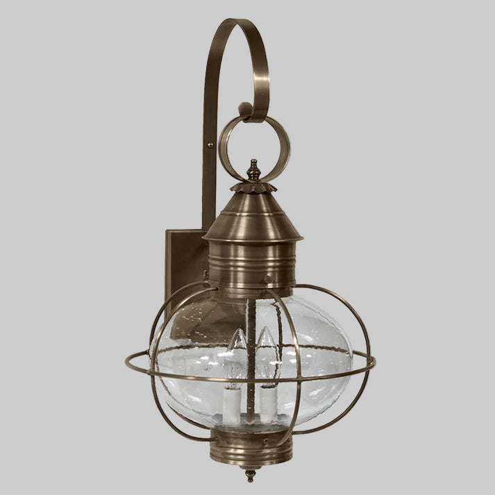 Bronze outdoor wall light fixture with clear glass shade on a white background
