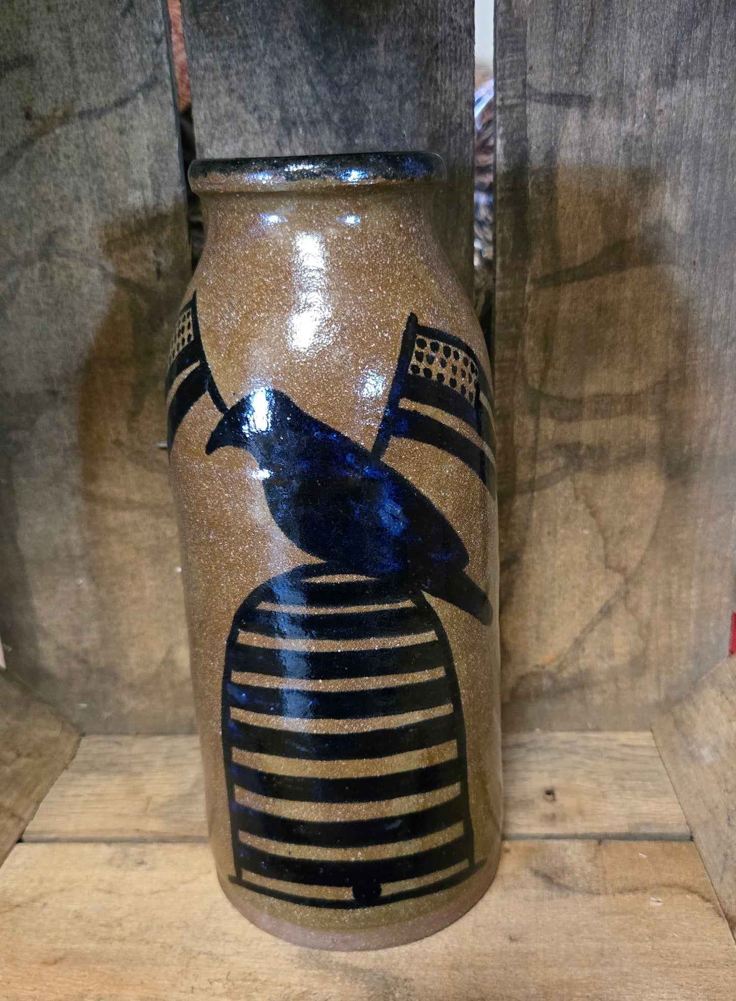 Stoneware crock with crow and flags