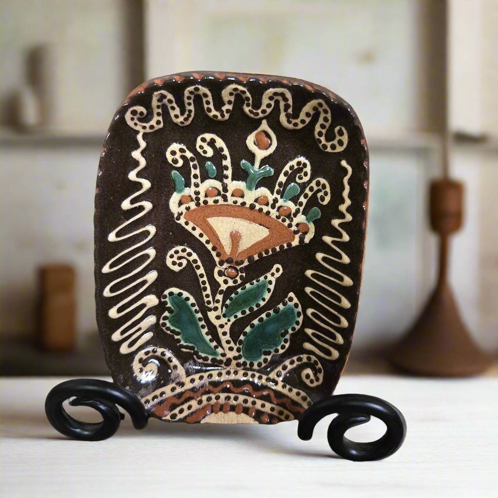 Small rectangular ceramic plate featuring a tulip with elaborate glazing techniques