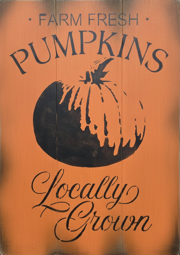 A wooden sign with an orange background, featuring the text 'Farm Fresh Pumpkins' and a pumpkin graphic, placed against a door.
