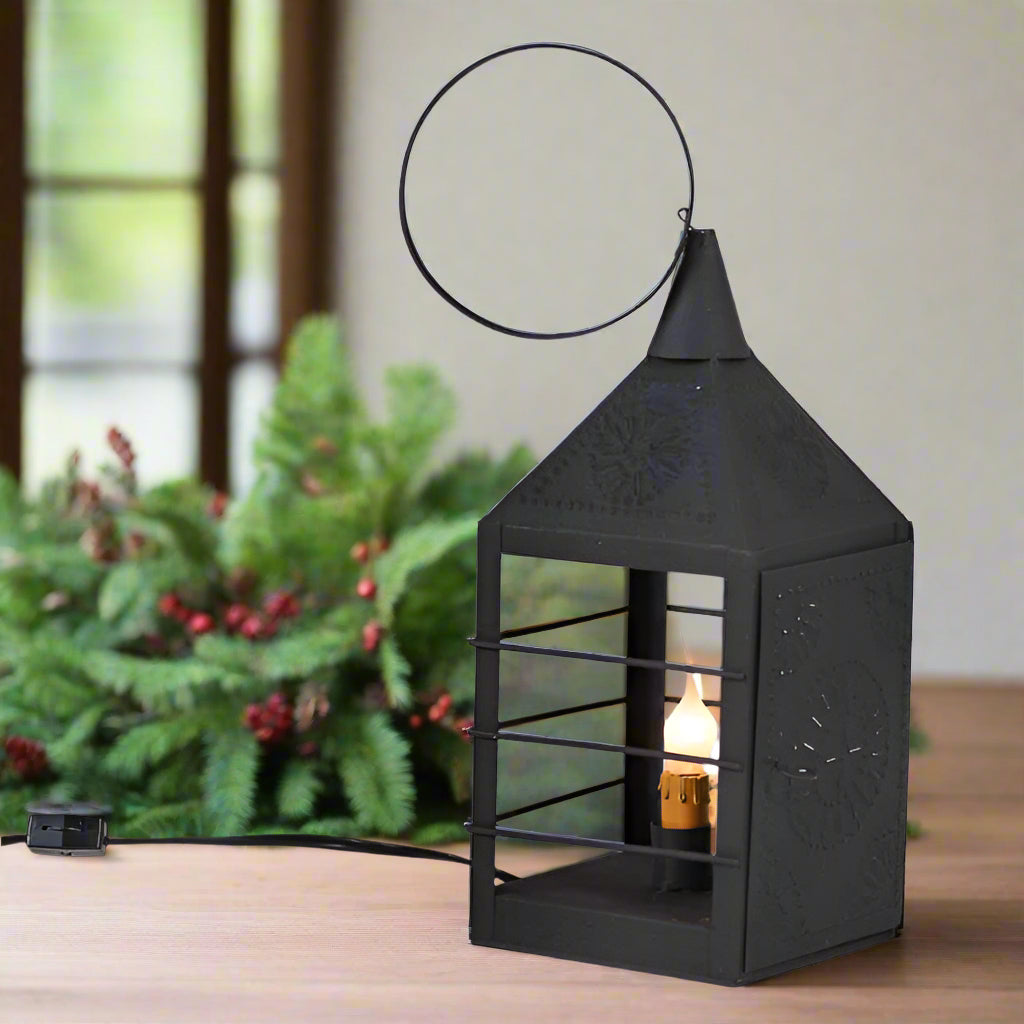 Black decorative lantern with a light bulb inside on a white background