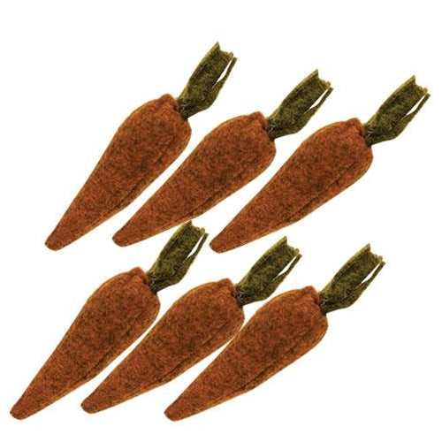6 felted carrots on a white background.