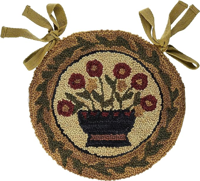 A round chair pad with a floral basket design, featuring multicolored flowers in a brown background, with a hooked chair pad made of a textural material, adorned with a dark green border.