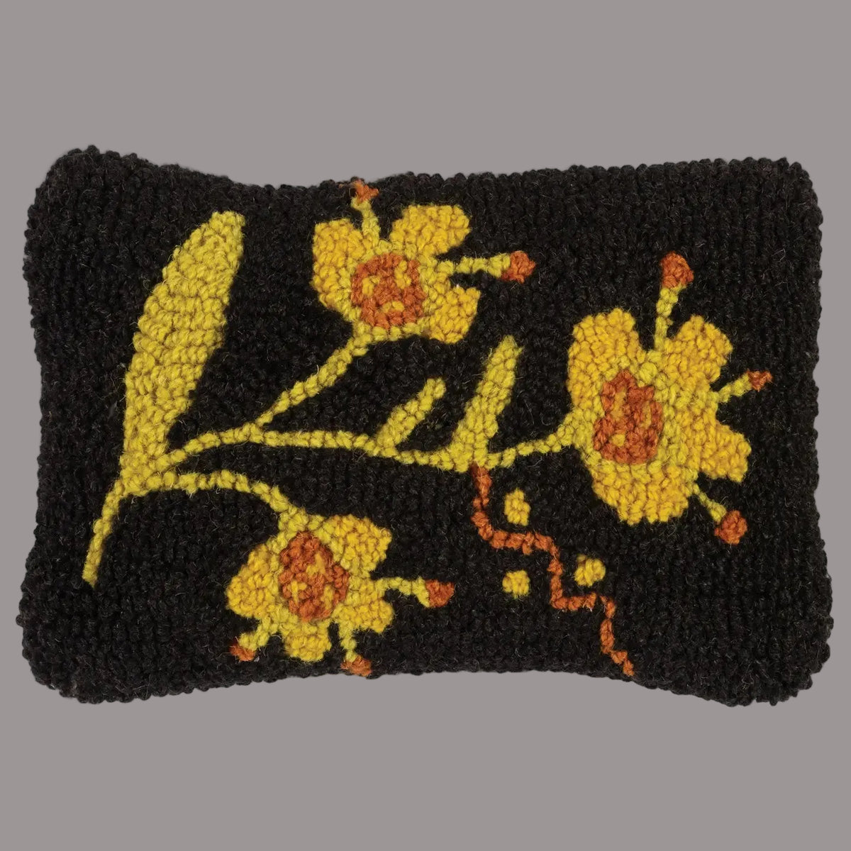 Decorative mat with yellow floral design on a black background