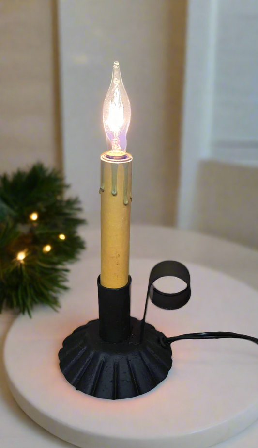 A textured black lamp with a clear glass bulb and a wired electrical cord.
