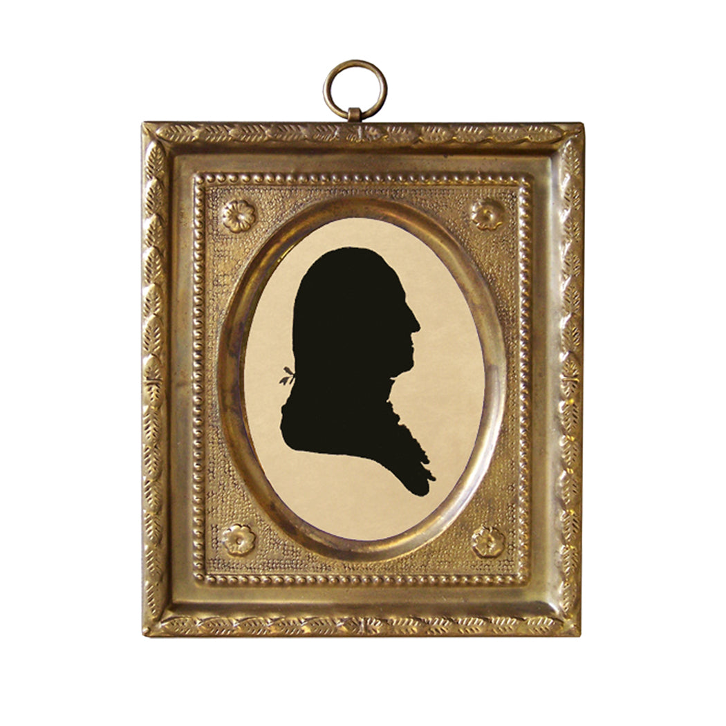 A brass framed miniature silhouette of George Washington with a black outline.