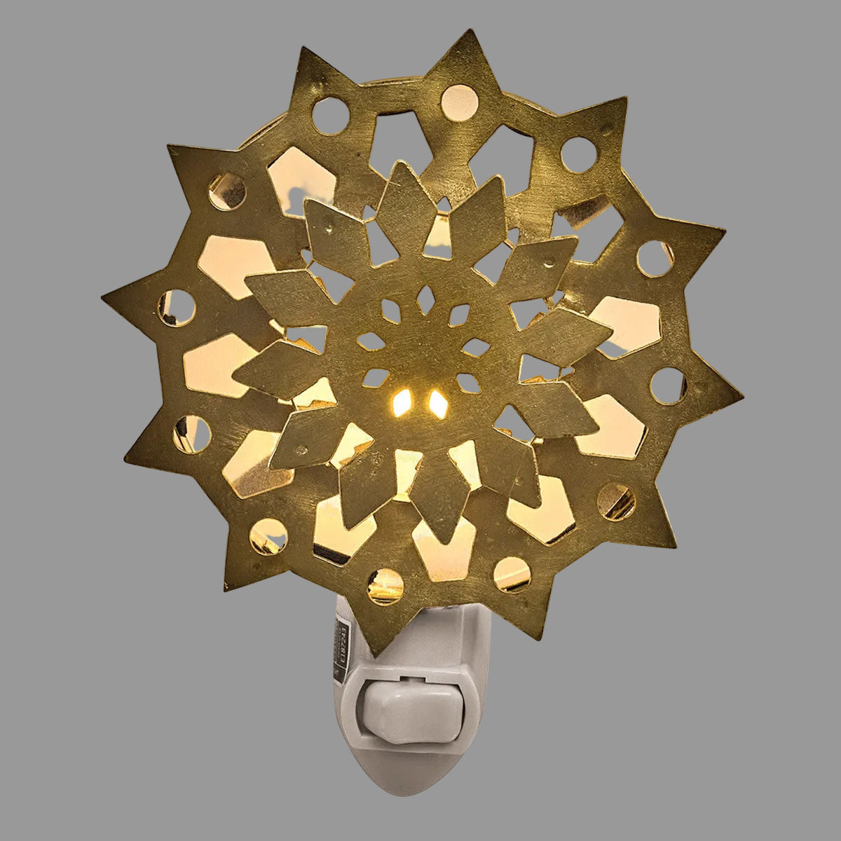 Gold snowflake nightlight on white background