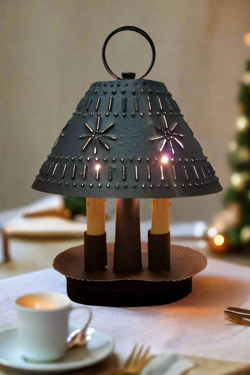 A textured black oval double light with a mushroom-like top and two candelabra sockets at the base, set on a circular brown base.