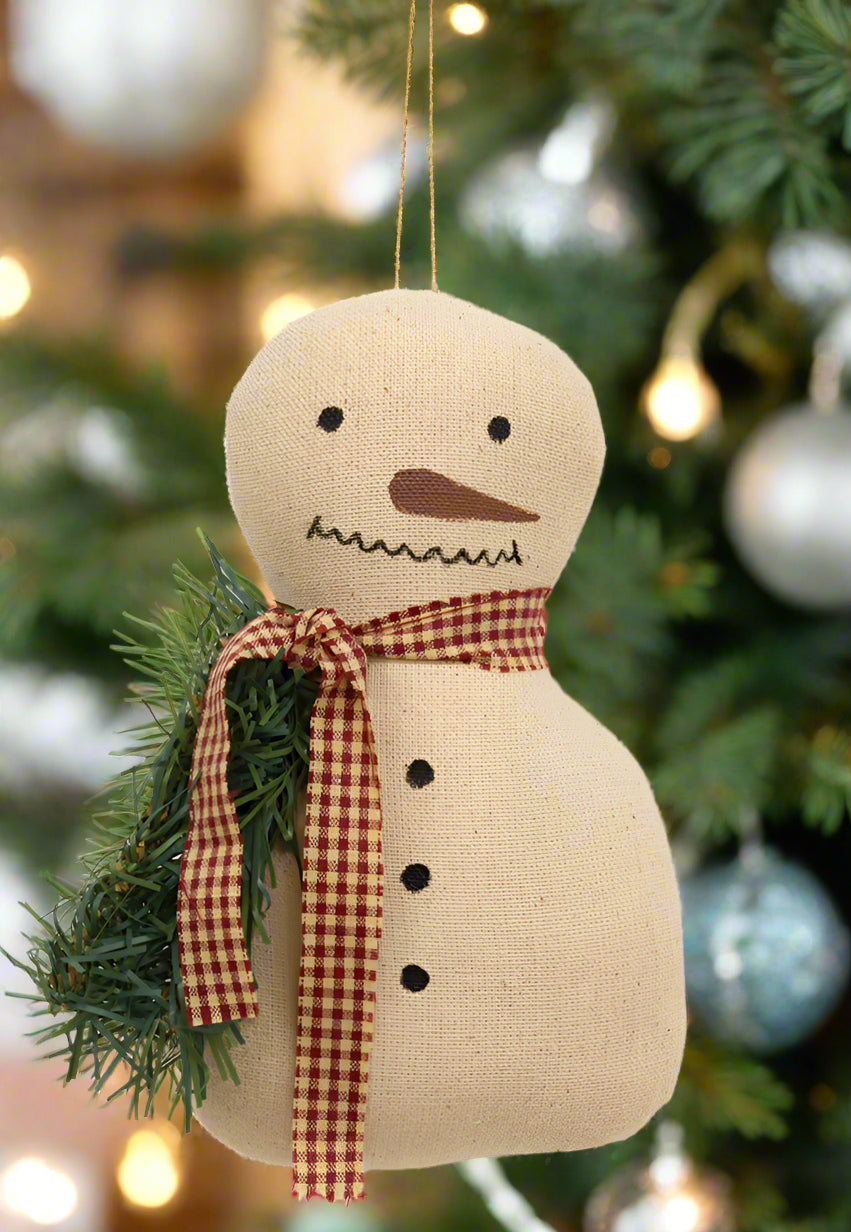 Primitive snowman ornament with checked scarf and greens