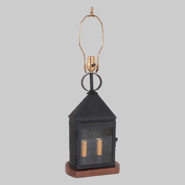 Black lantern-style lamp with brass accents on a white background