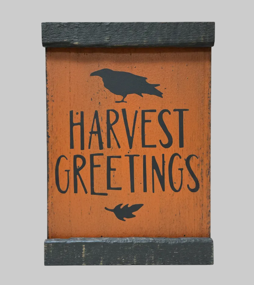 Decorative sign with 'Harvest Greetings' text and a silhouette of a bird on an orange background.