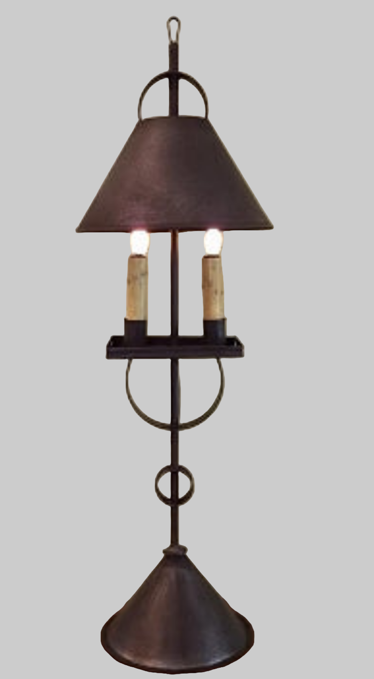 A dark brown tin table lamp with a conical shade, featuring two candle-like light bulbs.