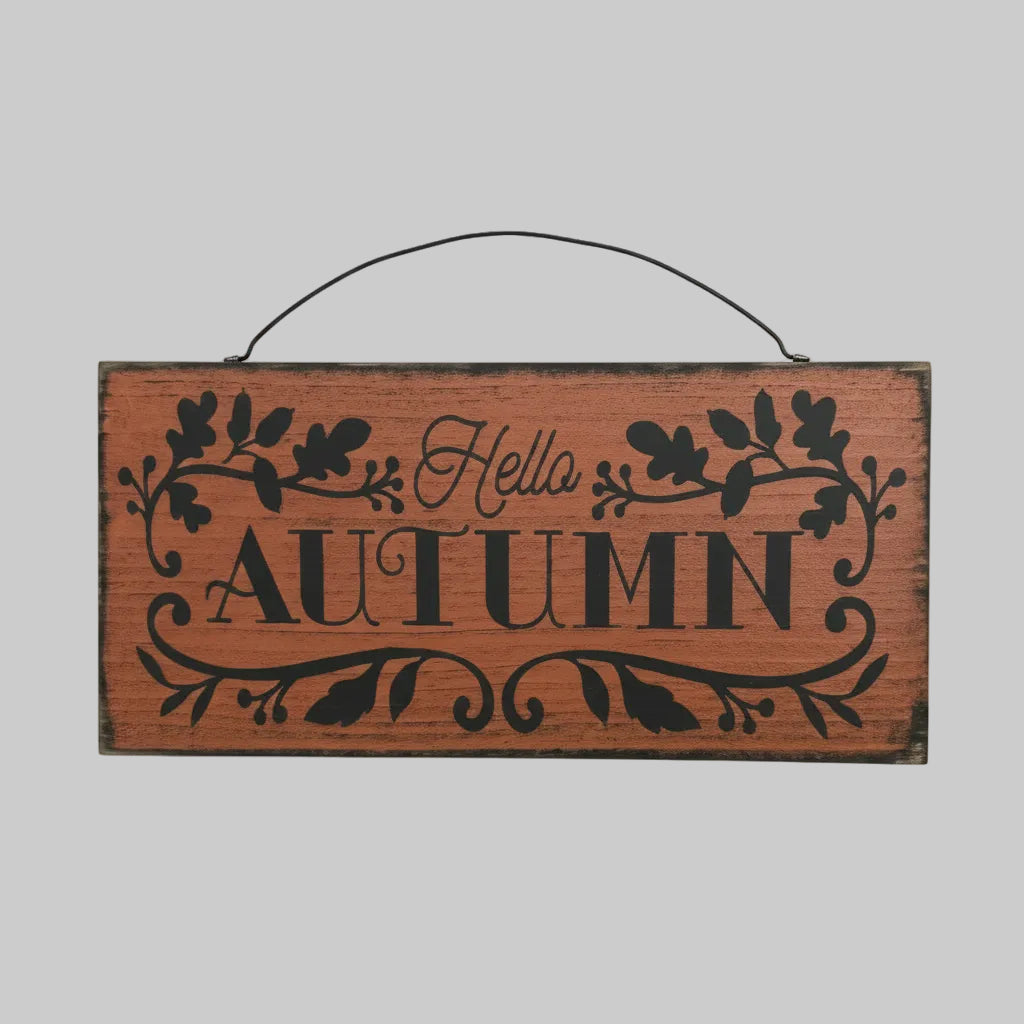 Wooden sign with 'Autumn Hello' text on a wooden background