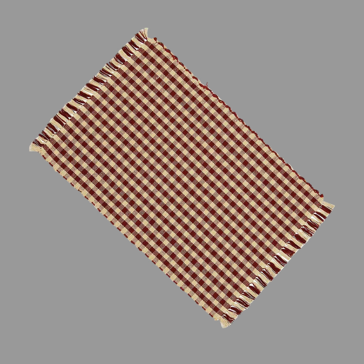 A rectangular barn red cotton placemat with a checkered pattern.