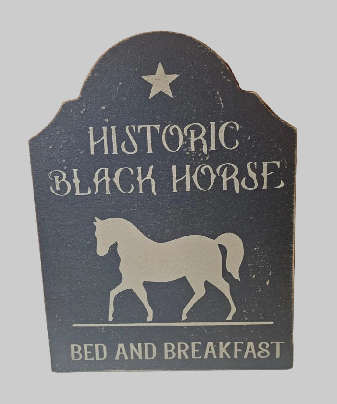 Decorative sign for Historic Black Horse Bed and Breakfast with a horse silhouette and star on a dark background.