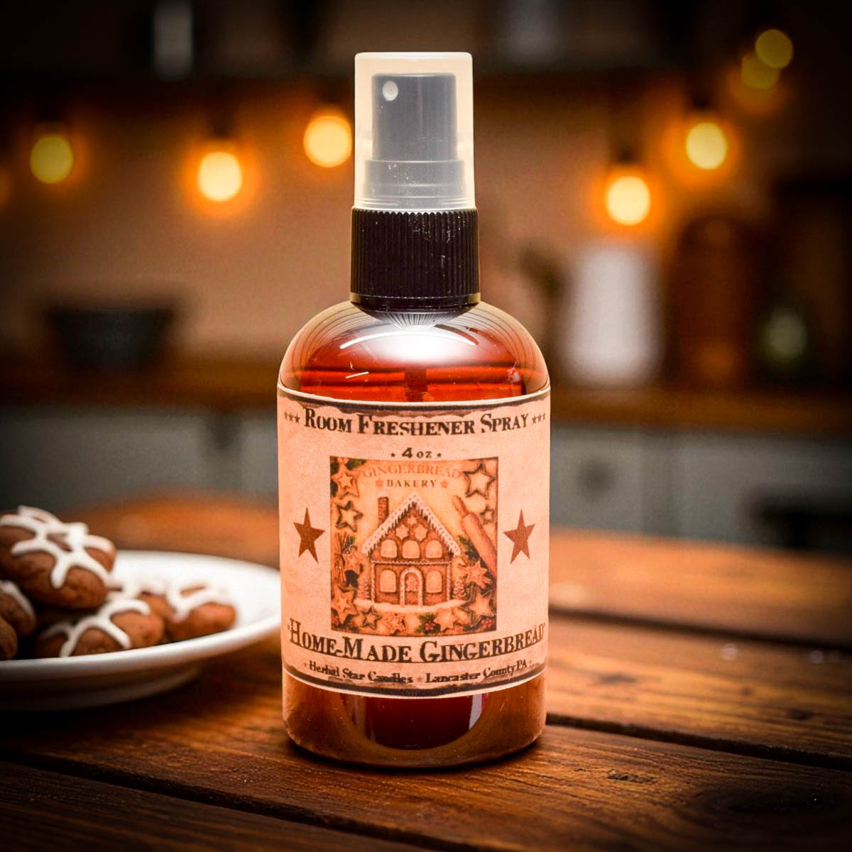 Room freshener spray bottle labeled 'Home Made Gingerbread' on a wooden surface with blurred background