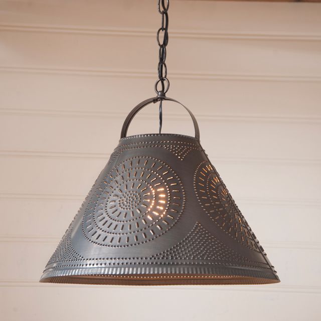 Decorative pendant light with intricate design on a neutral background