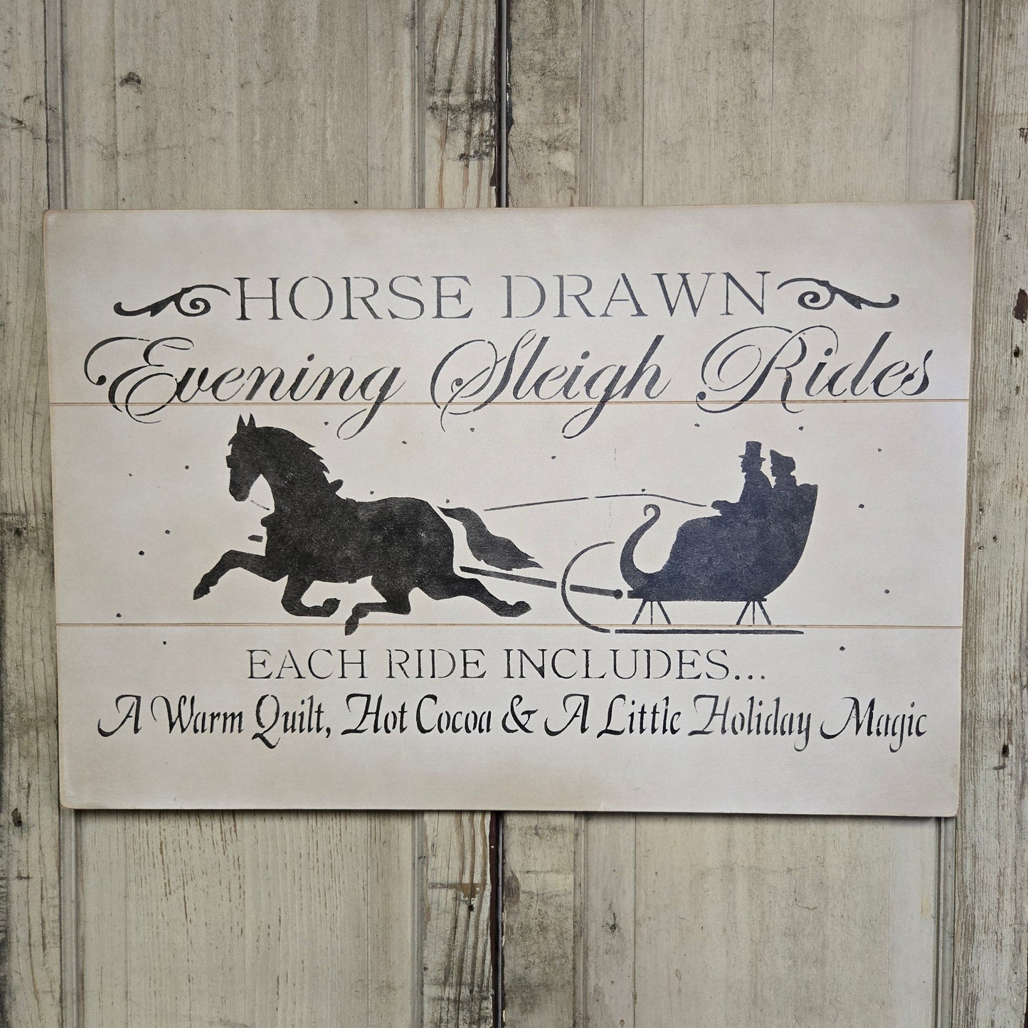 Weathered sign with horse and sleigh with some text