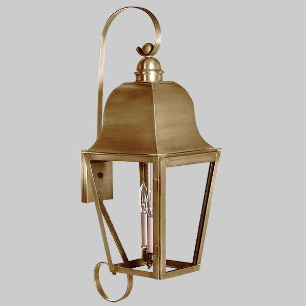 Brass wall-mounted lantern on a gray background