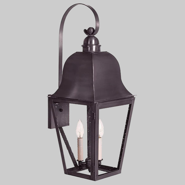 Decorative outdoor lantern with two candle-like lights on a gray background