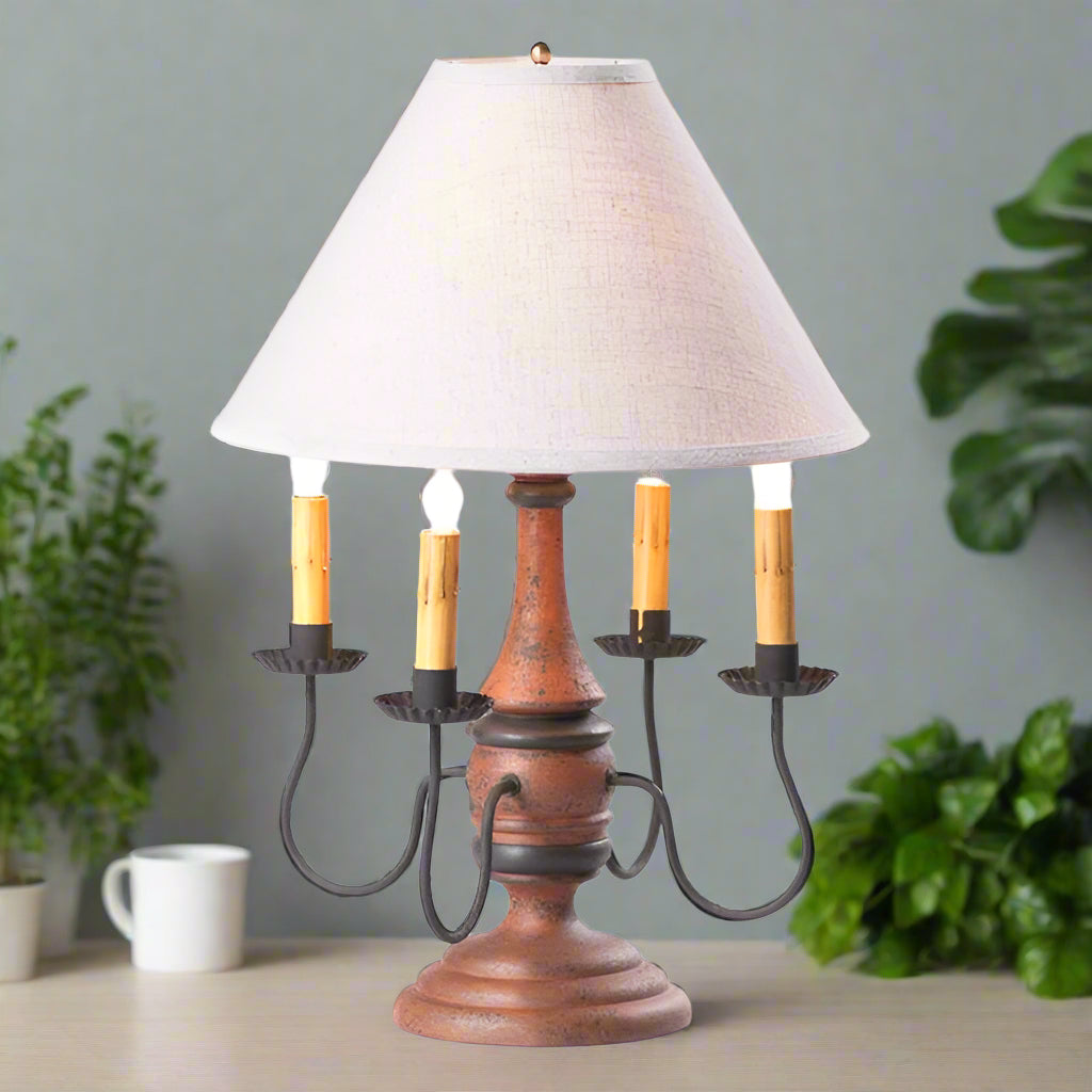 Decorative table lamp with wooden base and white shade on a white background