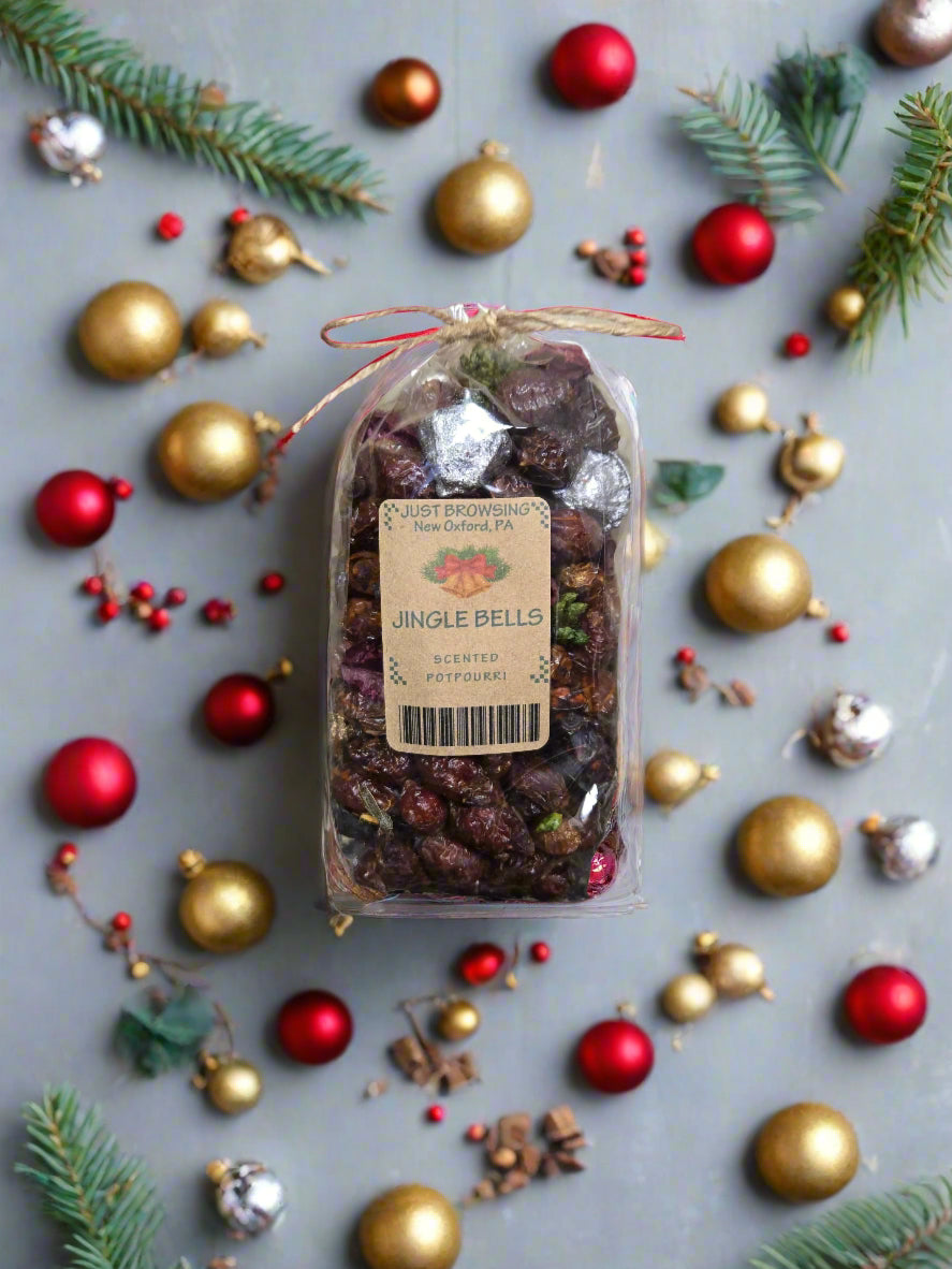 Packaged product labeled 'Jingle Bells' surrounded by Christmas decorations on a gray background