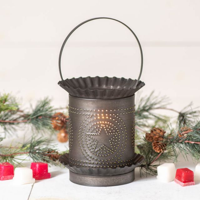 Decorative metal lantern with star design on a white background with Christmas decorations.