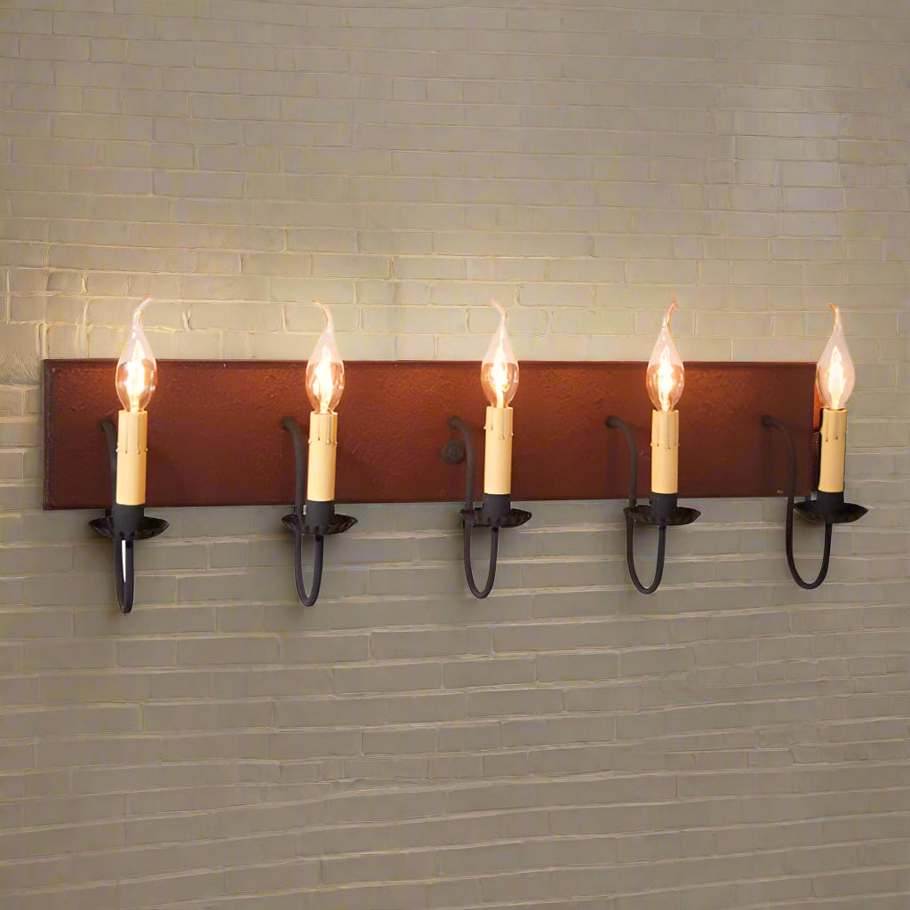 A five-light vanity light fixture with a textured plantation red finish and black textured arms, featuring E12/Candelabra sockets.